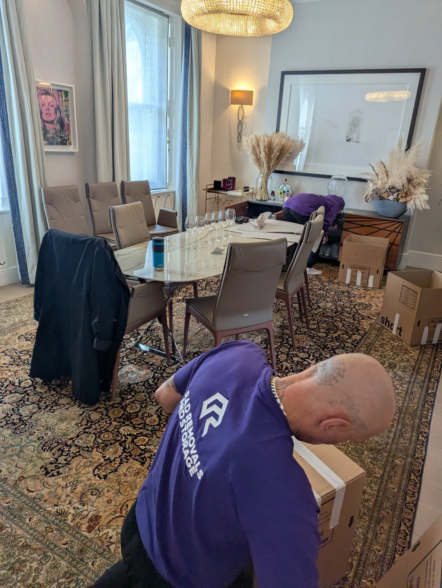 Rad Removals crew packing up a living room in West Kensington, showcasing professional packing services in action